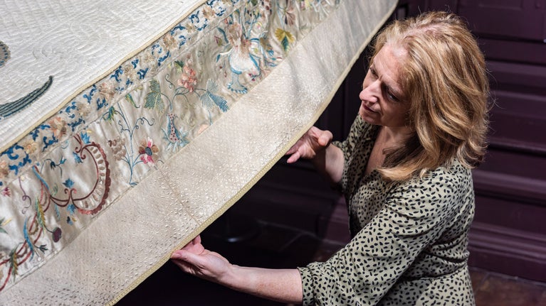 Erddig Property Curator Susanne Gronnow examines the bed cover